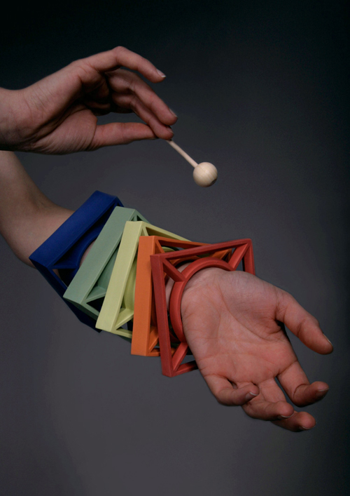 A series of brightly colored bangles, square-shaped, playable by a xylophone mallet.