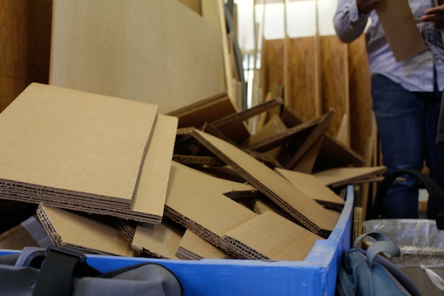 A tub with scraps of cardboard, overflowing, all shapes and sizes.