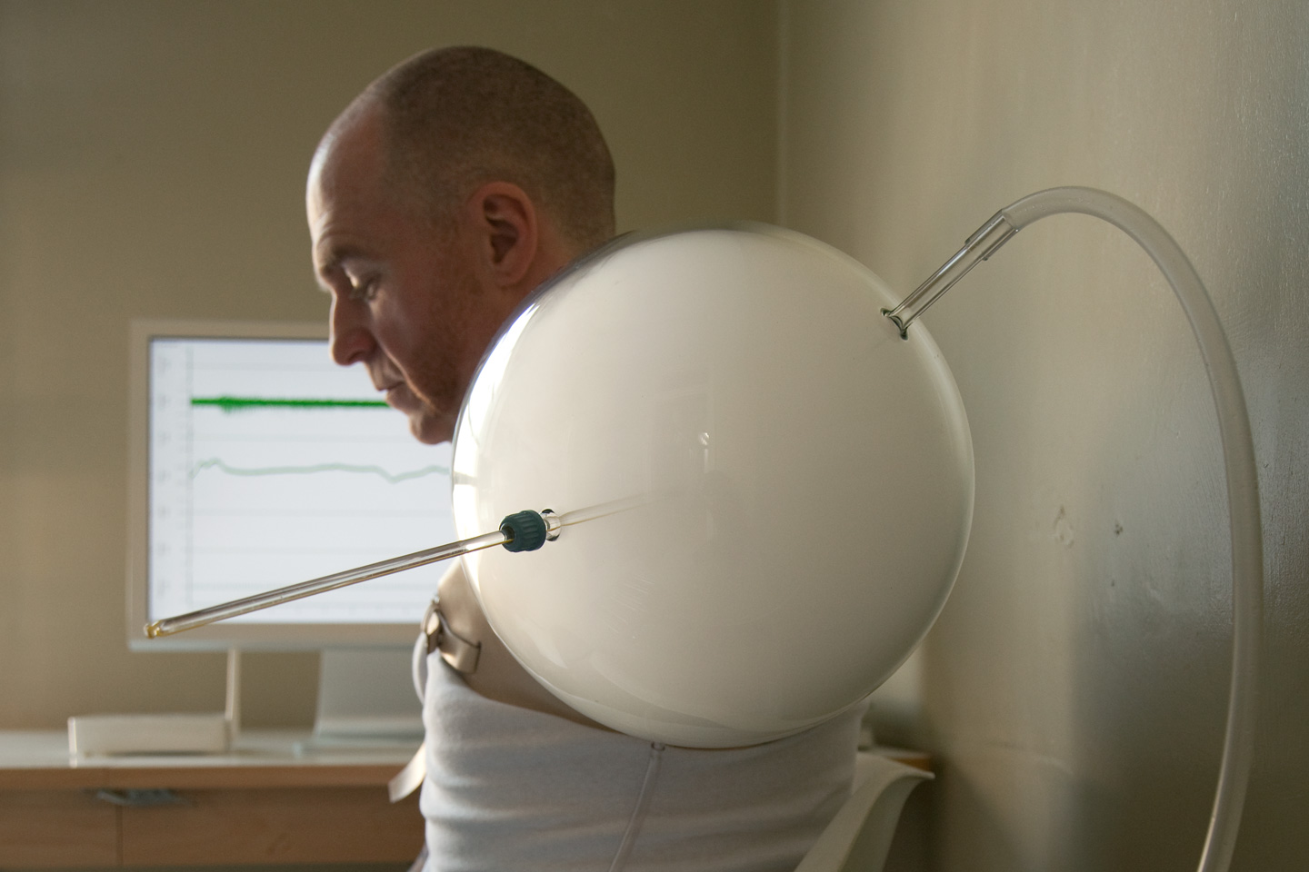 A side view close up of the balloon-and-straw arm fitting.